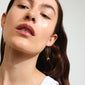 LYSANDRA chain earrings gold-plated, featuring delicate bow pendants, showcased on a woman with long hair. Perfect for adding elegance to any outfit.