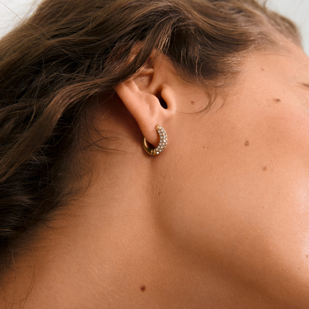 TATUM small hoops gold-plated, featuring sparkling Preciosa crystals. Elegant, versatile design with snap locks, perfect for elevating any outfit from day to night.