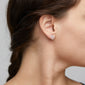 Close-up of a woman's ear adorned with Pilgrim's silver-plated GEORGINA ear studs, symbolizing the Tree of Life, embodying strength and growth.