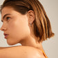 ELANOR rustic texture hoop earrings, silver-plated, inspired by Nordic minimalism, featuring a raw surface texture, worn by a woman with short brown hair.