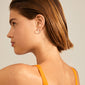 Silver-plated Elanor rustic texture hoop earrings, showcased on a woman with short hair, highlighting their handcrafted, nature-inspired design and minimalist Nordic elegance.