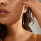 Woman wearing EUONIA gold-plated pearl chain-earrings, showcasing a blend of elegance and versatility, with removable pearls for a unique, classic look.
