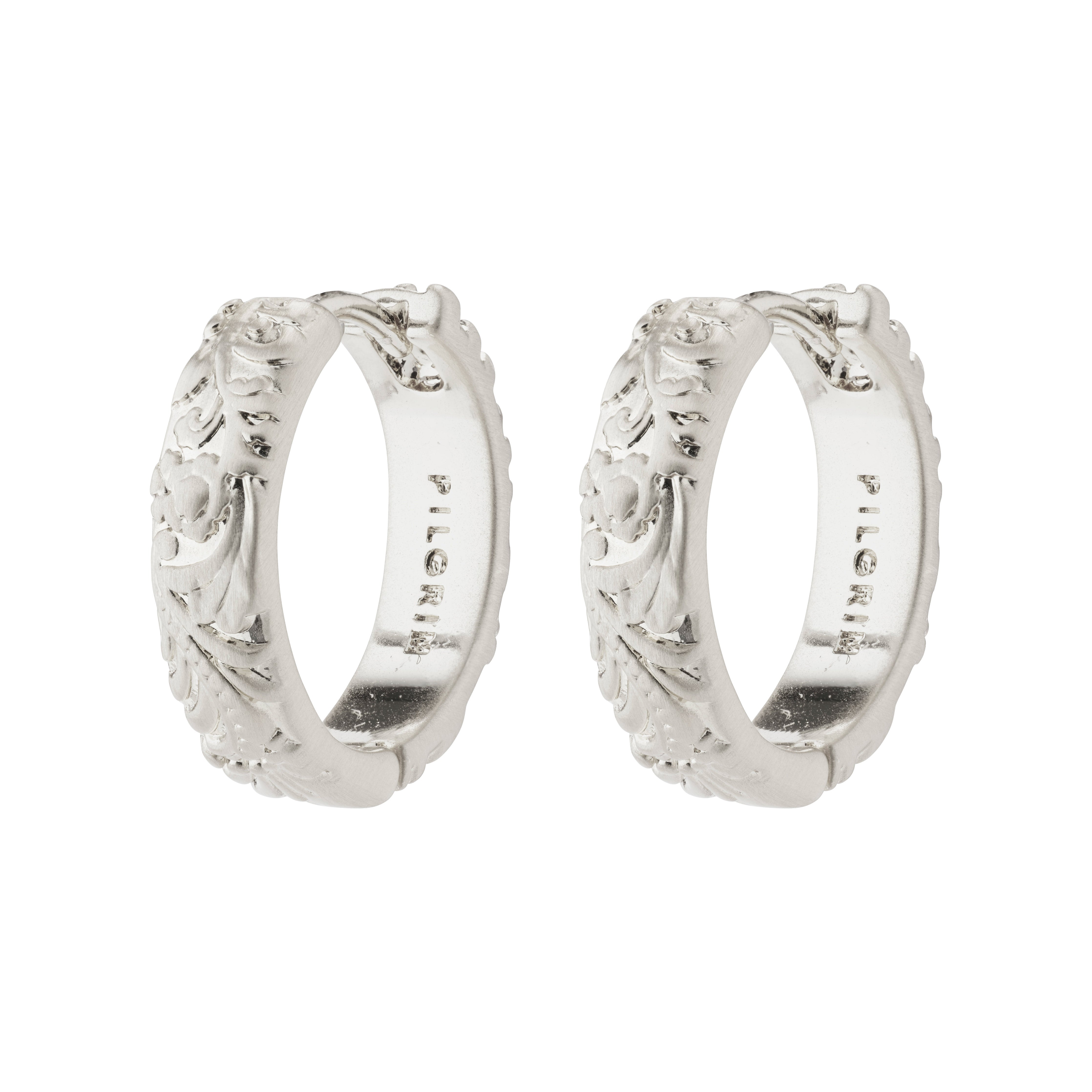 ELFRIDA hoop earrings silver-plated with nature-inspired carvings of flowers and leaves, featuring a satin-matte finish and convenient click lock closure.