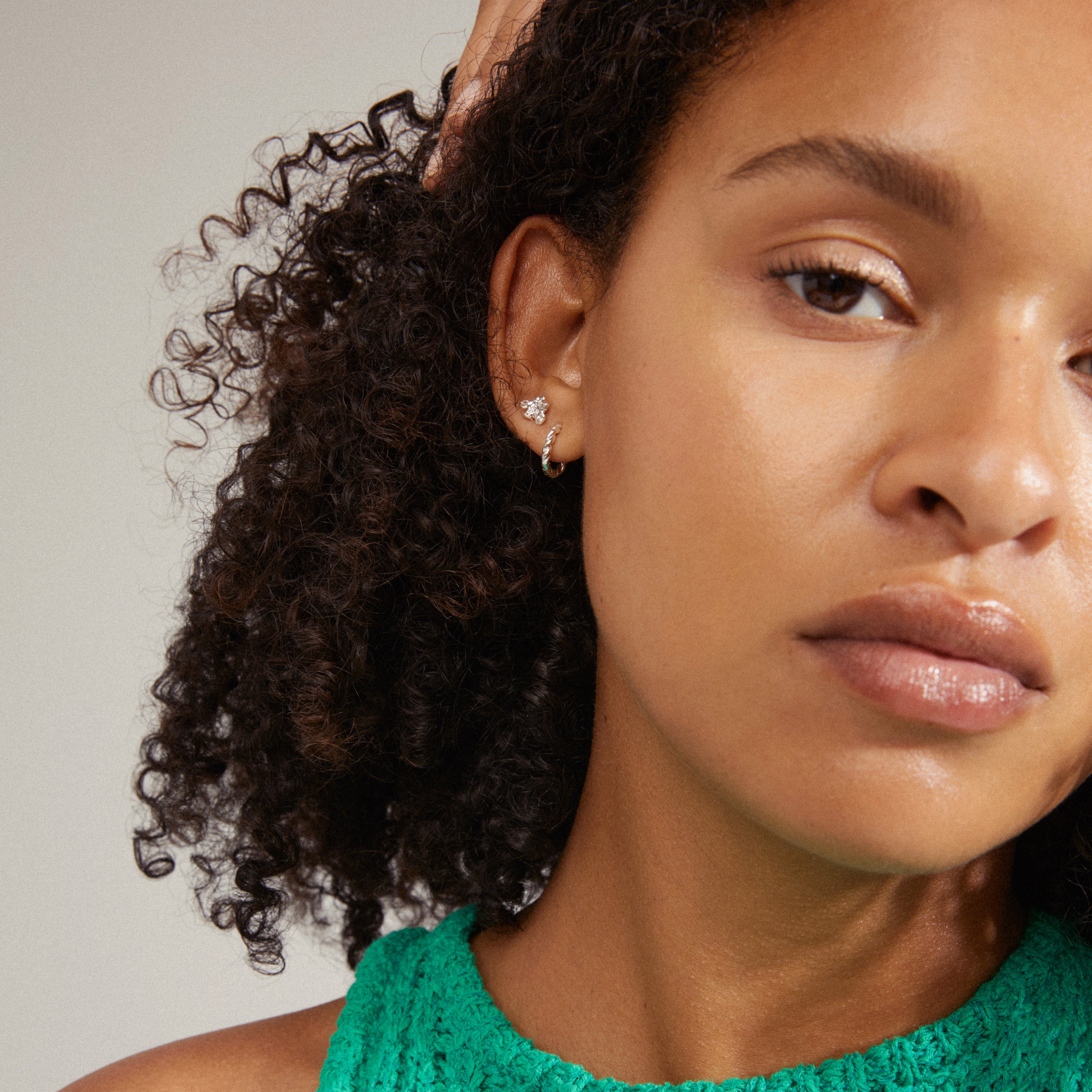 EMANUELLE earrings 3-in-1 set silver-plated, featuring intricate twist design huggie hoops, organic ear studs, and crystal micro studs, all crafted with 86% recycled materials.