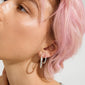 Close-up of ear with Pilgrim's EVE silver-plated hoop earrings 2-in-1 set, showcasing layered minimalist style with two distinct silver hoops.