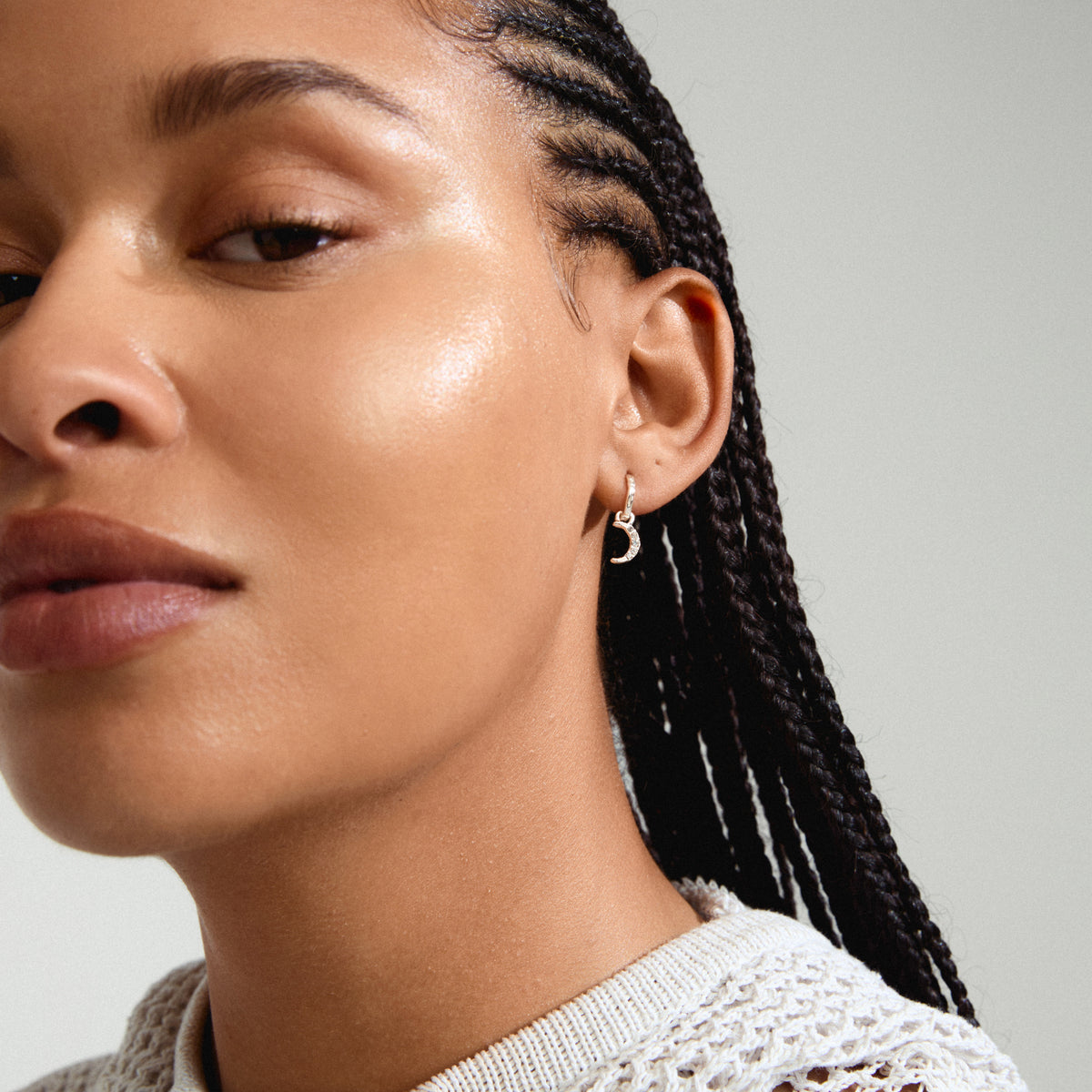 EVGENIA earrings silver-plated featuring a moon pendant with Preciosa crystals, worn by a woman with braided hair. Perfect for a luxurious boho look.