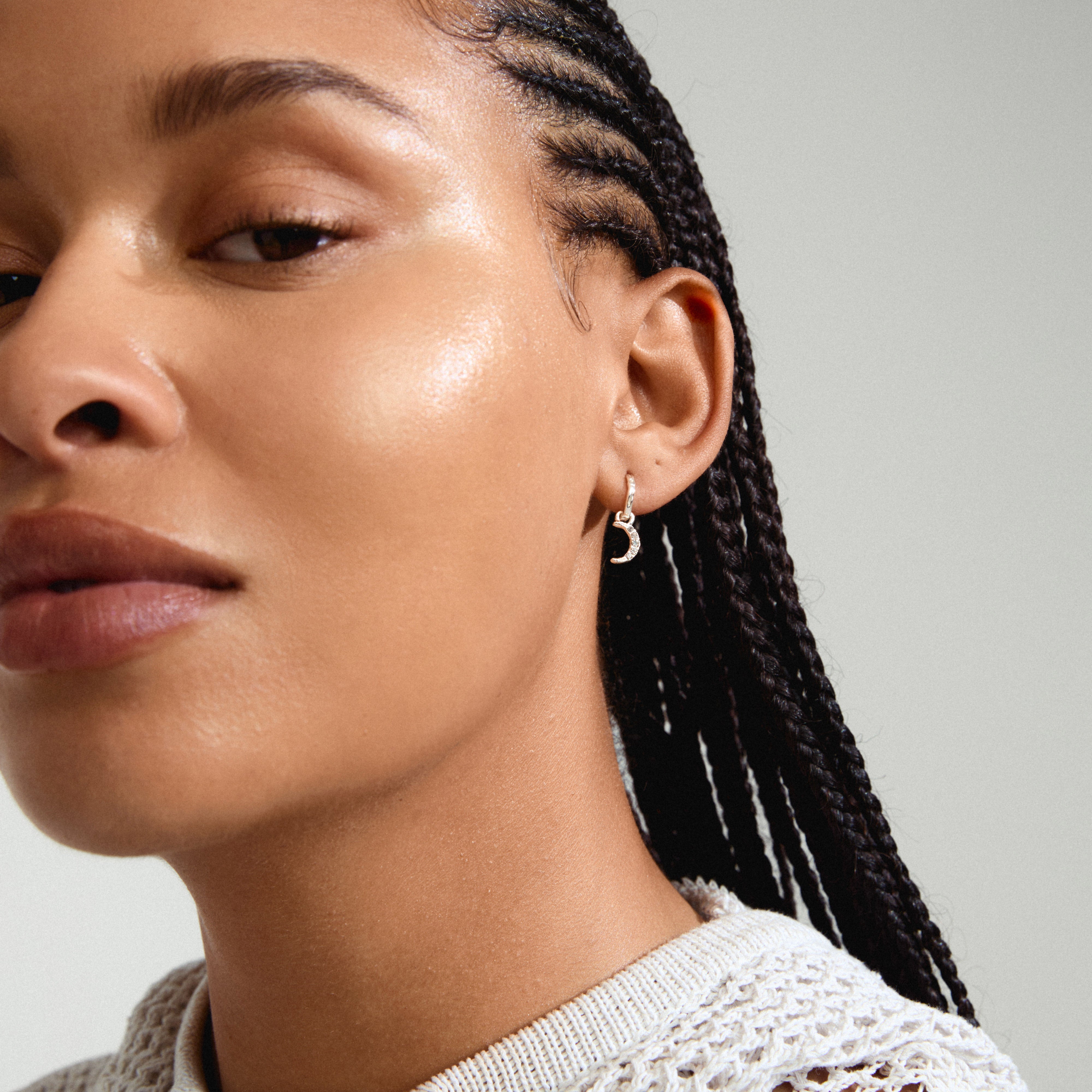 EVGENIA earrings silver-plated featuring a moon pendant with Preciosa crystals, worn by a woman with braided hair. Perfect for a luxurious boho look.