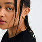 NEVAEH gold-plated chunky huggie hoops with petite Preciosa crystals, featuring an easy click clasp. Made with 97% recycled material for a sparkling, sustainable style.