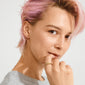 Young adult with pastel-pink hair showcasing the gold-plated TIMBER ring by Pilgrim, featuring abstract floral details, evoking nature's beauty and designed for stacking.