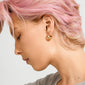 Side profile of a person wearing BRAXTYN gold-plated chunky hoop earring by Pilgrim, showcasing its shiny bubble dome silhouette and retro-inspired design.