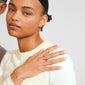 Young woman wearing Pilgrim's AIKO ring, a gold-plated, wavy band on her middle finger, showcasing a sleek, minimalist style with a cream top.
