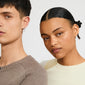 Close-up of models wearing Pilgrim's TIMBER silver-plated earrings with organic flower pendants, showcasing modern, versatile design suitable for daily wear.