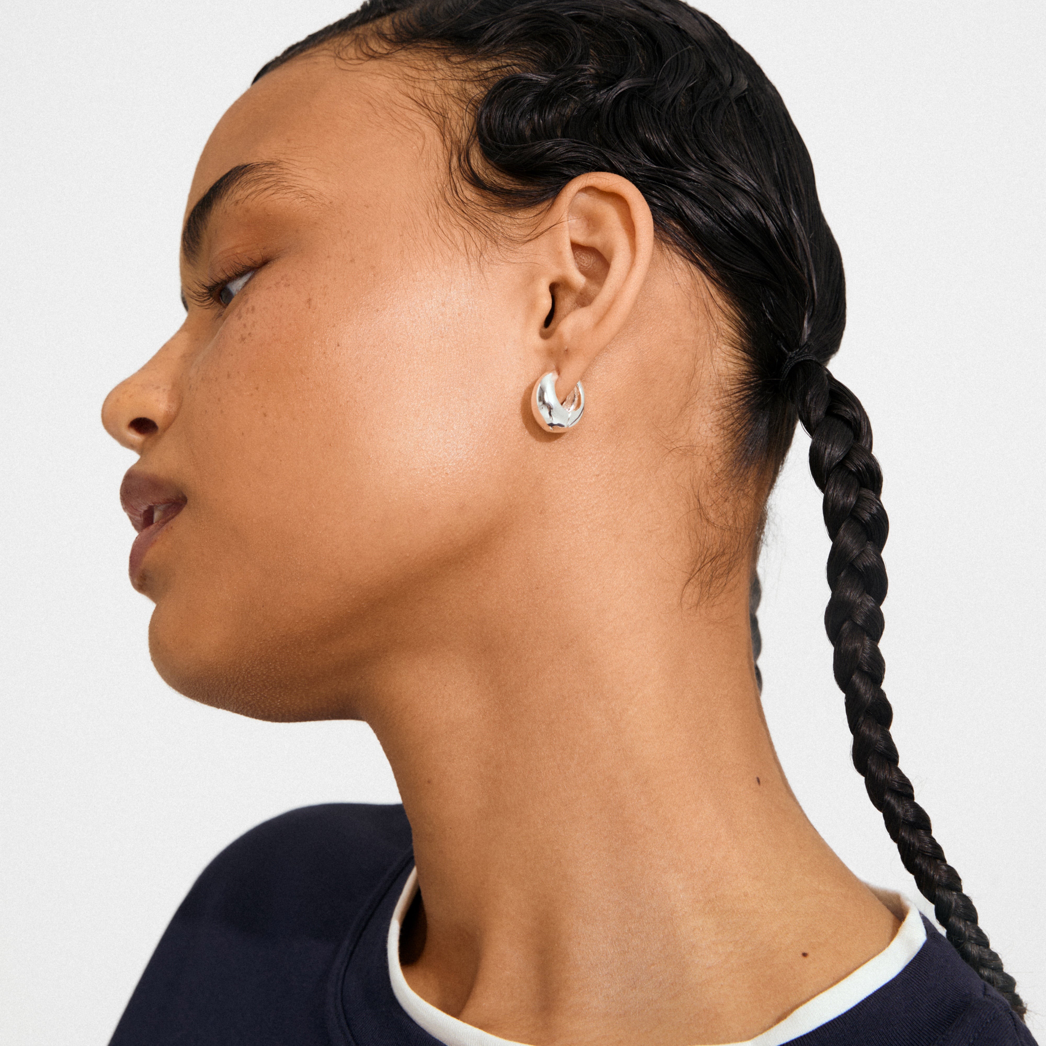 Side profile showcasing BRAXTYN silver-plated hoops by Pilgrim, highlighting their chunky, retro-inspired bubble dome design. Perfect for an effortlessly stylish, conscious fashion statement.