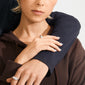Close-up of two hands wearing silver-plated BRAXTYN rings, highlighting their sleek, sculptural design, set against a casual embrace in a stylized portrait.