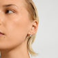 AIKO earrings silver-plated, featuring a wavy, zig-zag design, worn on a person's ear with slicked-back blonde hair, embodying modern elegance and edgy style.