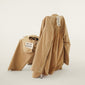 PILGRIM PJ set XS/S displayed on a chair, showcasing a relaxed and oversized fit with visible tags, highlighting its casual, effortless style.