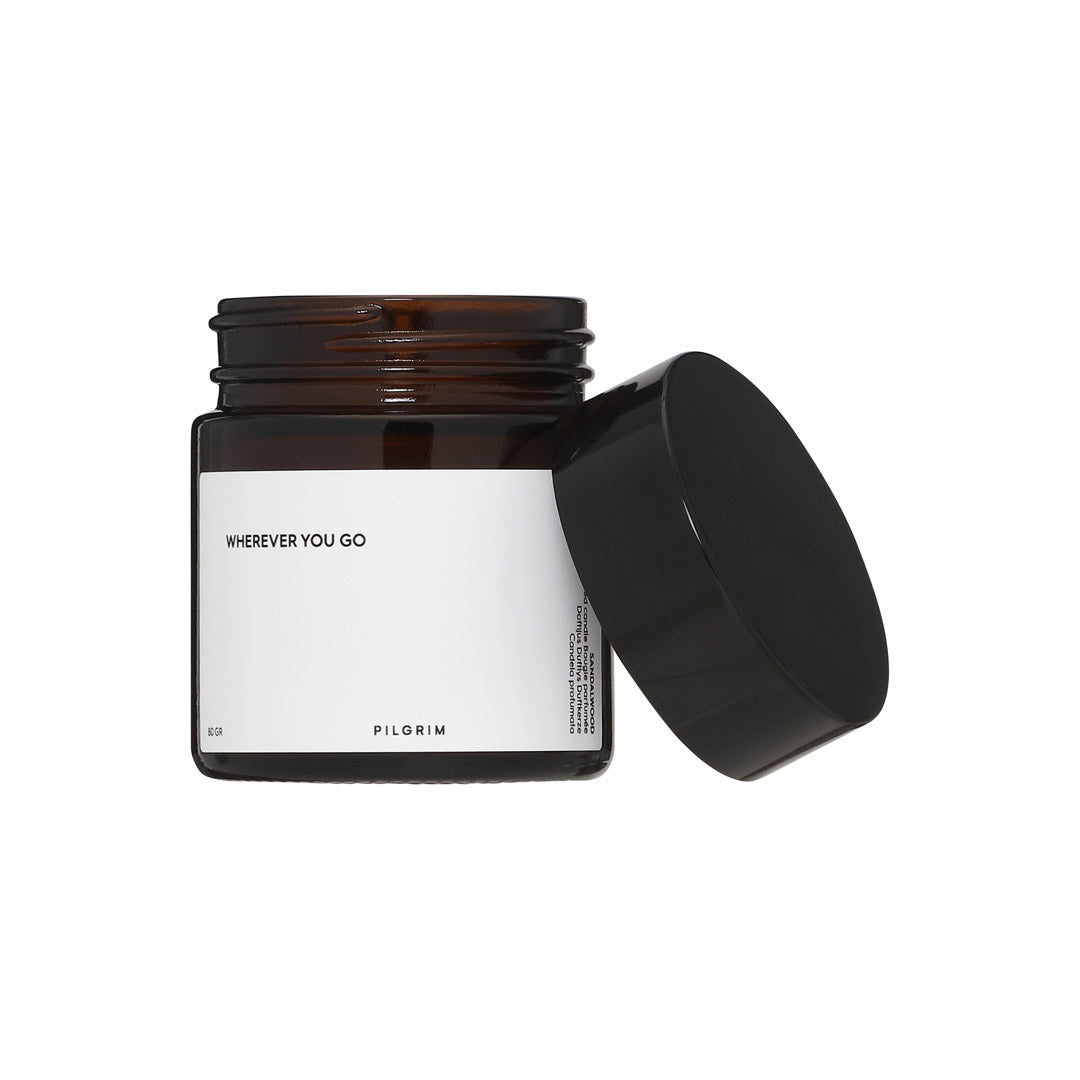 PILGRIM Scented candle with sandalwood aroma in a reusable glass, featuring a sustainable rapeseed wax and Eco-Tex cotton wick for a calming burn.