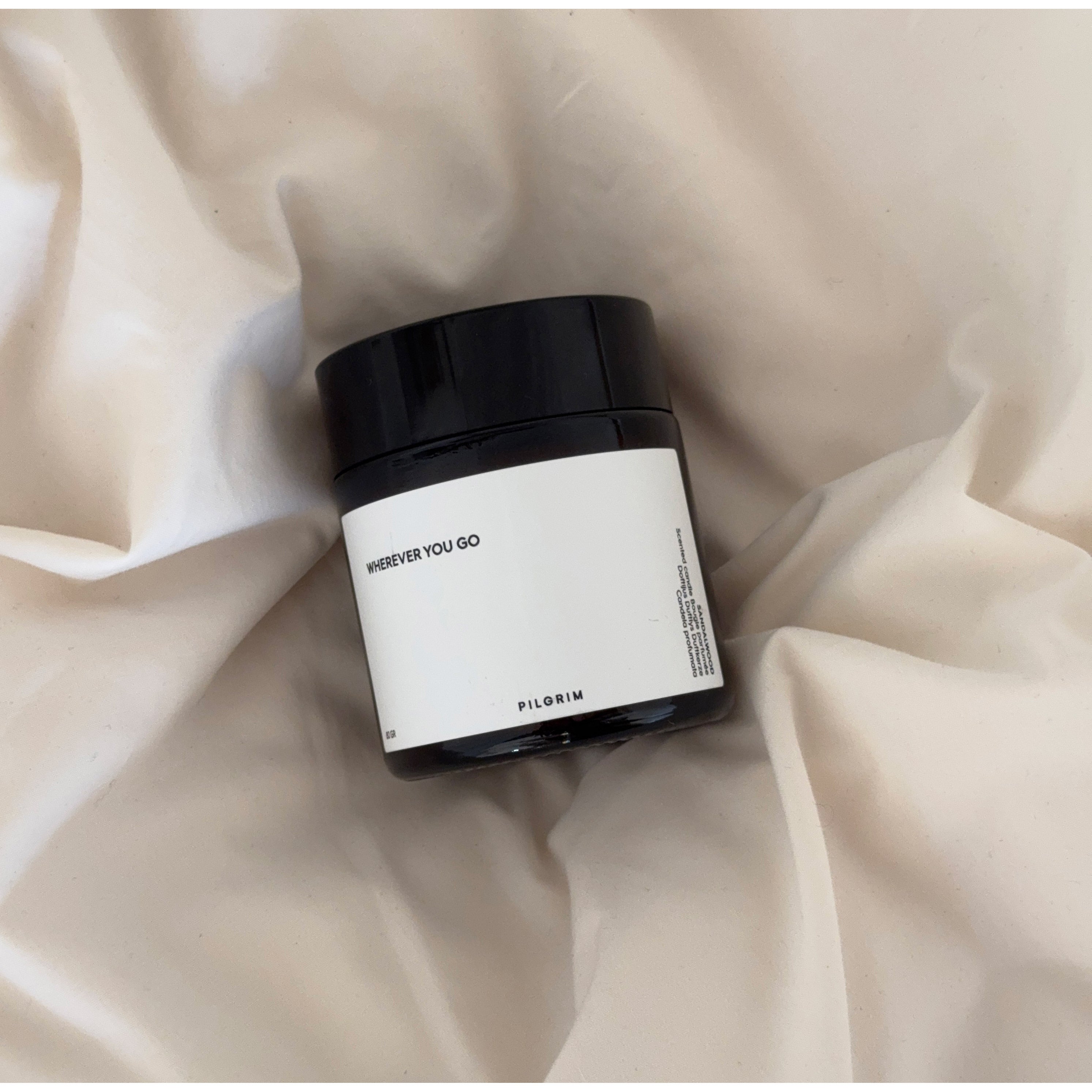 Close-up of the PILGRIM Scented Candle with a white label, featuring a sustainable rapeseed wax and Eco-Tex certified cotton wick for a serene, eco-friendly burn.