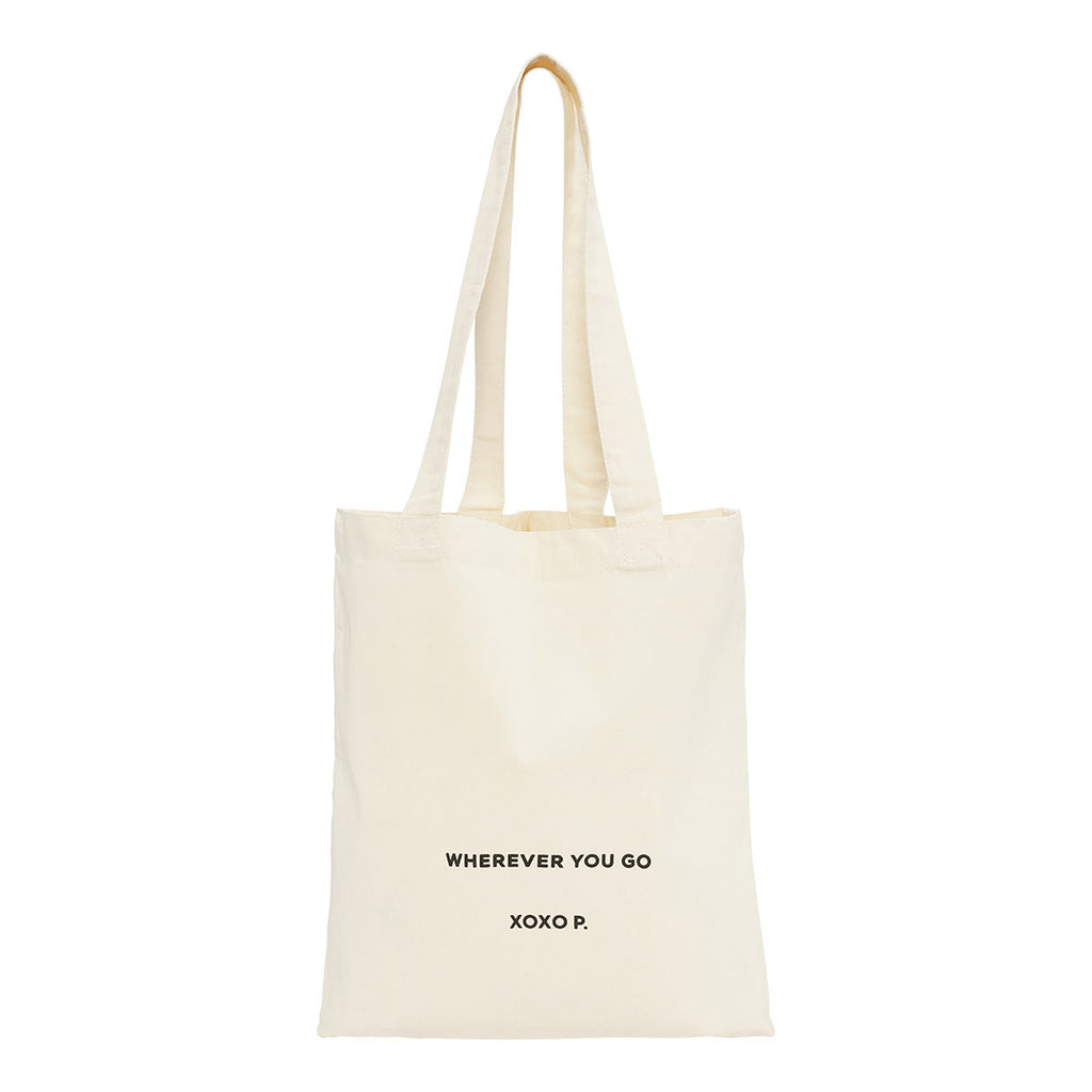 Off-white canvas tote bag with wherever you go print and long strap, perfect for daily essentials. Spacious, minimalist design by Pilgrim.