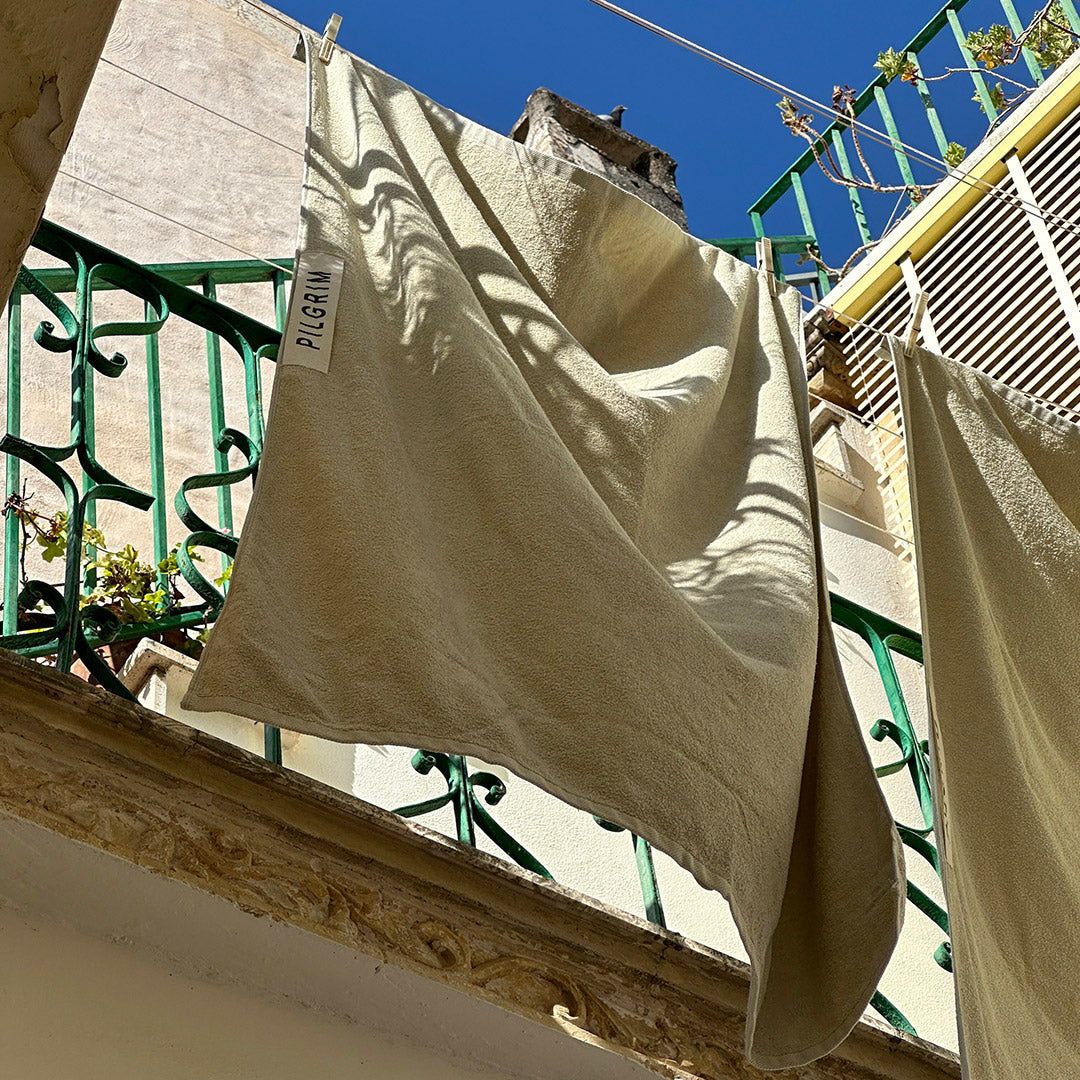 Beach Towel, 100 x 150 cm, beige with Pilgrim logo, crafted from organic cotton for luxurious comfort, ideal for sunbathing or beach outings.