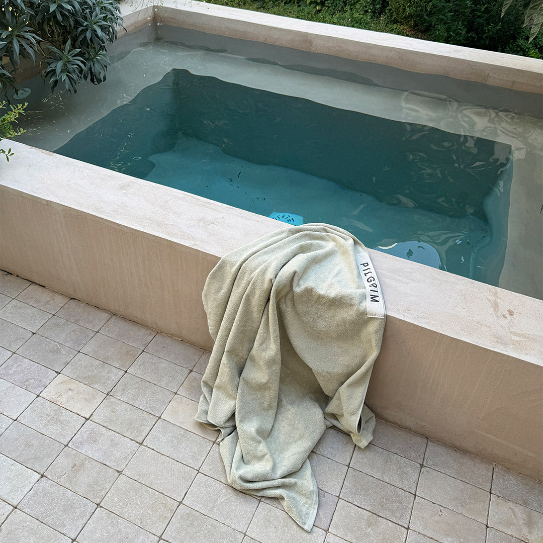 Beach Towel, 100 x 150 cm, beige with Pilgrim logo, ideal for sunbathing or post-swim comfort, crafted from organic cotton for a luxurious feel.