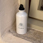 White 400 ml Pilgrim aluminium bottle with logo, featuring a minimalist design and carabiner for easy portability, ideal for active lifestyles.