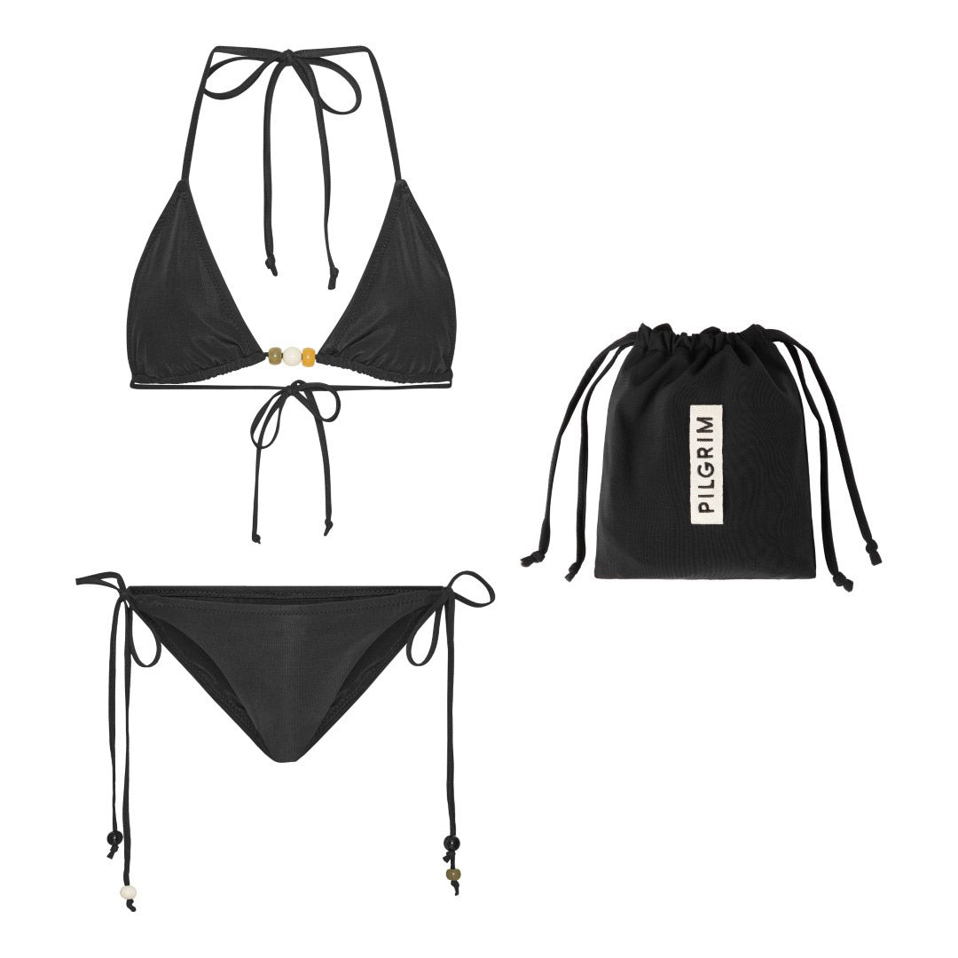 Black bikini in M/L featuring a triangle top with chunky beads, high-cut bottoms with side ties, and decorative straps. Comes in a sleek black drawstring pouch.