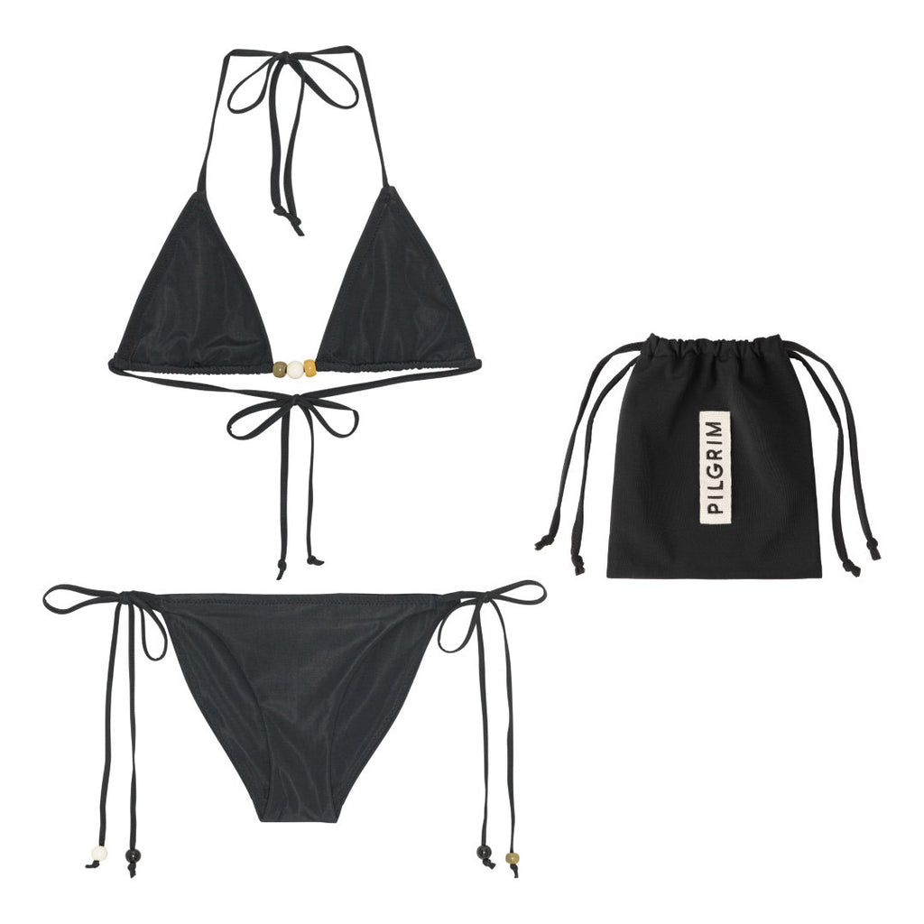 Black bikini with triangle top featuring white beads and a tie-neck halter, paired with high-cut bottoms and side ties, packed in a black drawstring pouch.