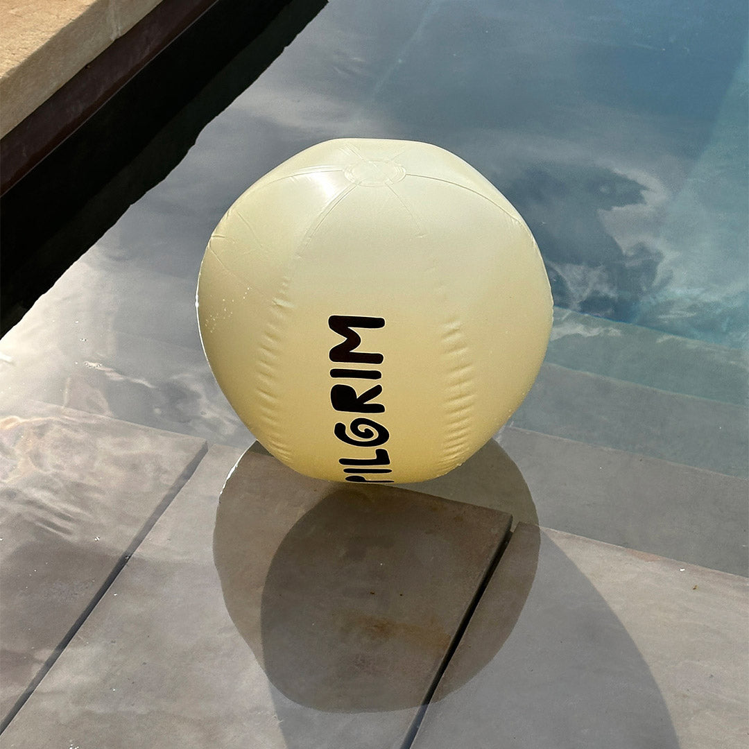 Off-white beach ball, 50 cm, with black Pilgrim logo, ideal for summer fun and spreading good vibes at the beach or pool.