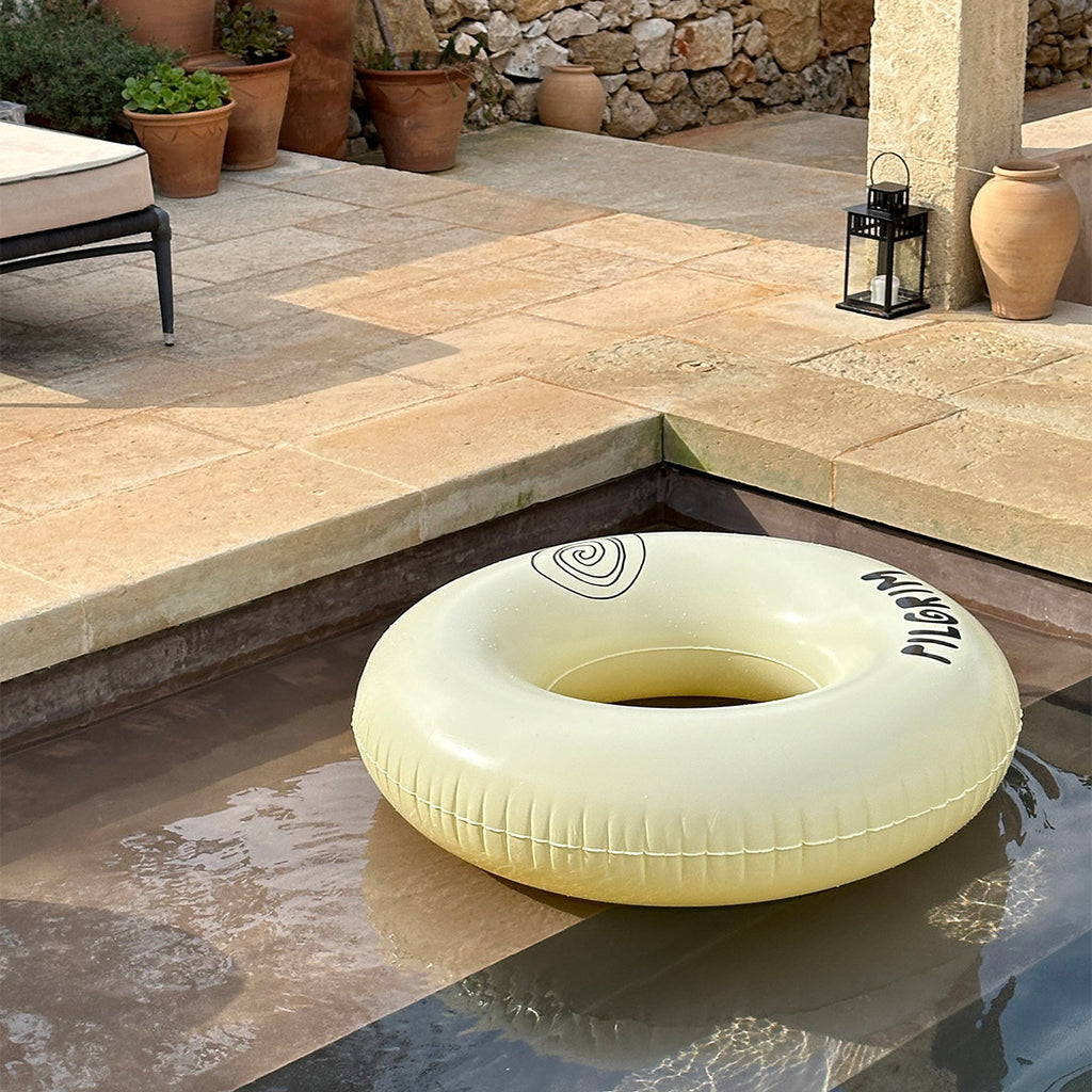 Off-white swim ring, 120 cm, featuring sleek black Pilgrim logo, ideal for summer relaxation by the pool or beach.