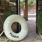 Off-white swim ring with Pilgrim logo, 120 cm diameter, ideal for stylish lounging by the pool or beach, embodying summer vibes and relaxation.
