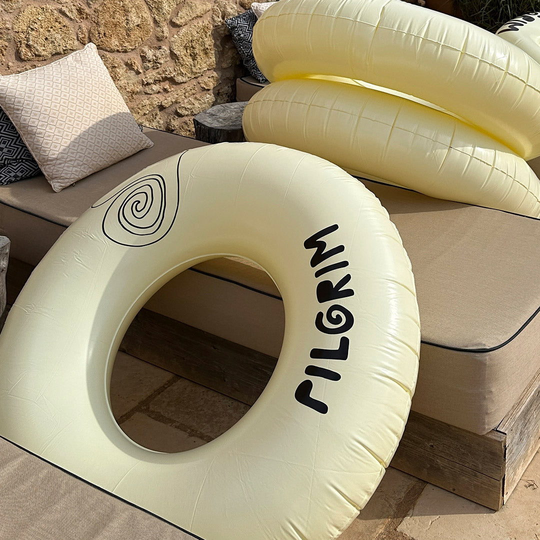 Off-white swim ring, 120 cm, features sleek black Pilgrim logo, ideal for stylish pool or beach lounging.