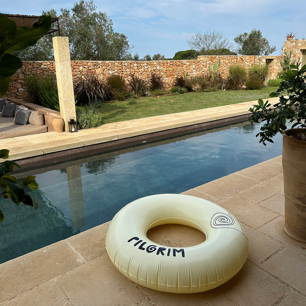 Off-white swim ring, 120 cm, featuring a sleek black Pilgrim logo, perfect for lounging poolside or relaxing at the beach.