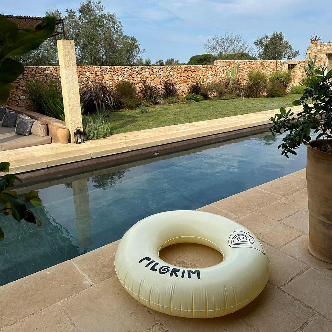 Off-white swim ring, 120 cm, featuring a sleek black Pilgrim logo, perfect for lounging poolside or relaxing at the beach.