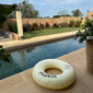 Off-white swim ring, 120 cm, featuring a sleek black Pilgrim logo, perfect for lounging poolside or relaxing at the beach.