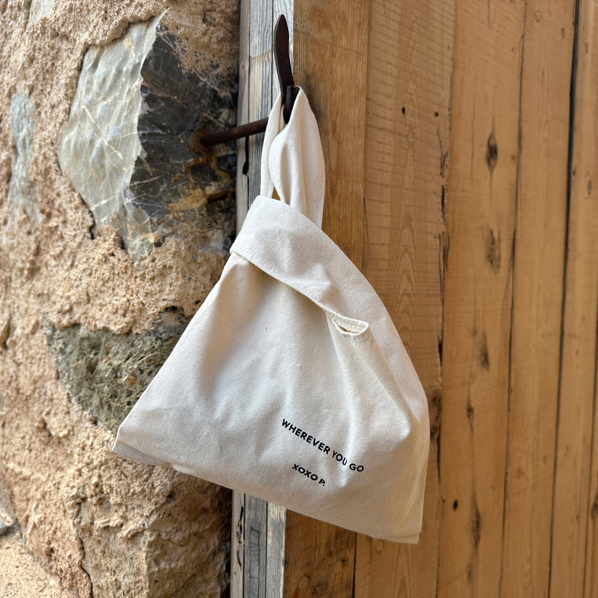Close-up of the Small Fashion canvas tote-bag in off-white, featuring broad woven straps and wherever you go print, embodying Pilgrim's minimalist and sustainable design.
