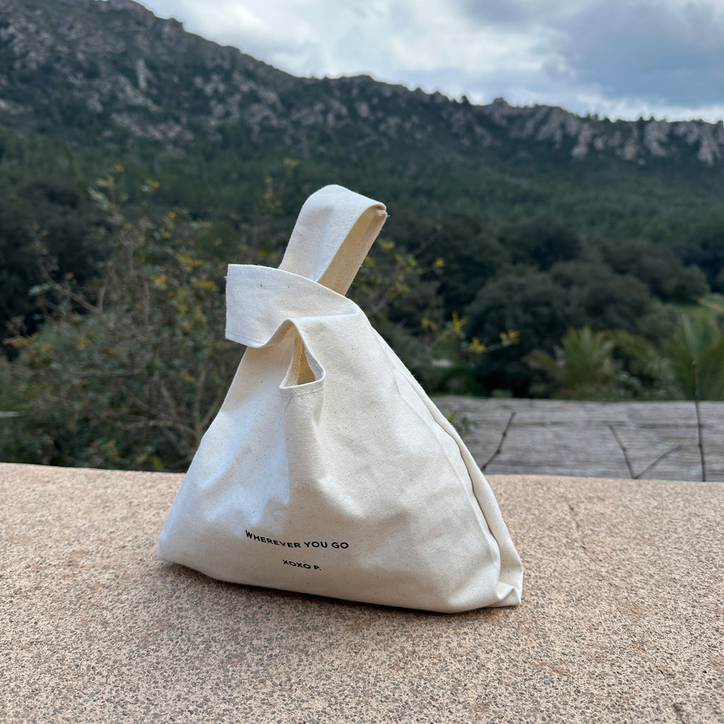 Small Fashion canvas tote-bag, off-white, with black wherever you go text, featuring broad woven straps, ideal for daily essentials and a minimalist look.