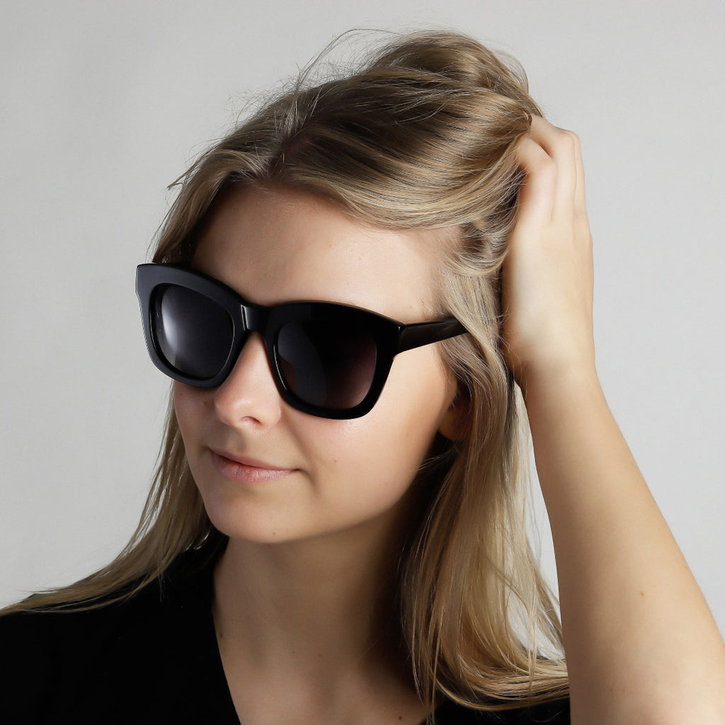 Dael sunglasses feature a chunky butterfly frame worn by a woman, embodying a trendy and cool look with full UVA/UVB protection.