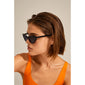 Woman in sunglasses wearing JOSELINE cat-eye sunglasses, showcasing Pilgrim’s trendy, retro-inspired eyewear with UVA/UVB protection.