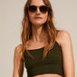 Woman wearing sunglasses with AJA curb chain for sunglasses, gold-plated, enhancing her stylish look with a trendy and functional accessory.