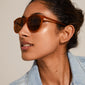 Woman wearing SAHARA classic acetate sunglasses in light brown, showcasing Pilgrim's bohemian-inspired eyewear with a light, durable frame.