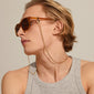 Man wearing SAHARA classic acetate sunglasses in light brown with an attached chain, showcasing Pilgrim's bohemian-inspired, durable, and stylish eyewear.