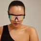 DEYLERT sunglasses in black, worn by a woman, showcasing Pilgrim's trendy shield design with UVA/UVB protection and a sustainable pouch for storage.
