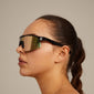 DEYLERT sunglasses black by Pilgrim, worn by a woman, showcasing shield design and UVA/UVB protection, perfect for trendsetters seeking unique style.