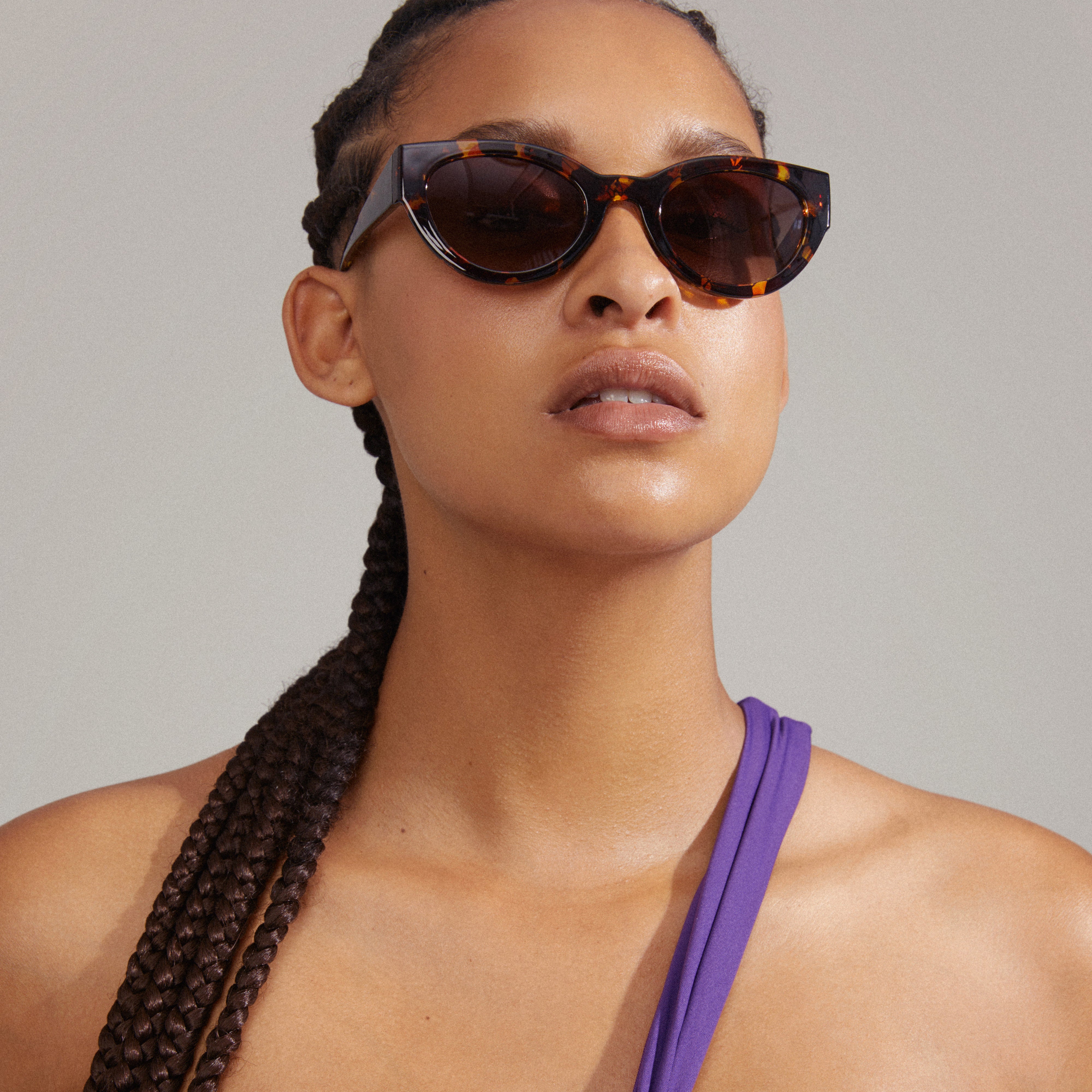 JUNA cat-eye sunglasses in tortoise brown, featuring a retro-inspired design with graduated lenses, worn by a woman, highlighting Pilgrim's blend of style and quality.