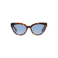 RAISA sunglasses tortoise brown in a close-up, showcasing their elegant cat-eye design. Made from 75% recycled plastic with UV400 lenses, embodying Pilgrim's timeless yet trendy style.