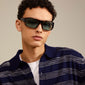 Man wearing GERTRUD sunglasses tortoise brown from Pilgrim, featuring light blue lenses, designed for a trendy and powerful look with UV protection.