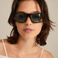Gertrud sunglasses tortoise brown on a woman's face, showcasing trendy light blue lenses and classic design, embodying Pilgrim's blend of timeless style and edge.