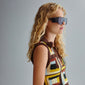 Woman wearing JOHARI sunglasses with black oversized frames, showcasing trendy L.A. style. Features UVA/UVB protection and sustainable materials from Pilgrim.