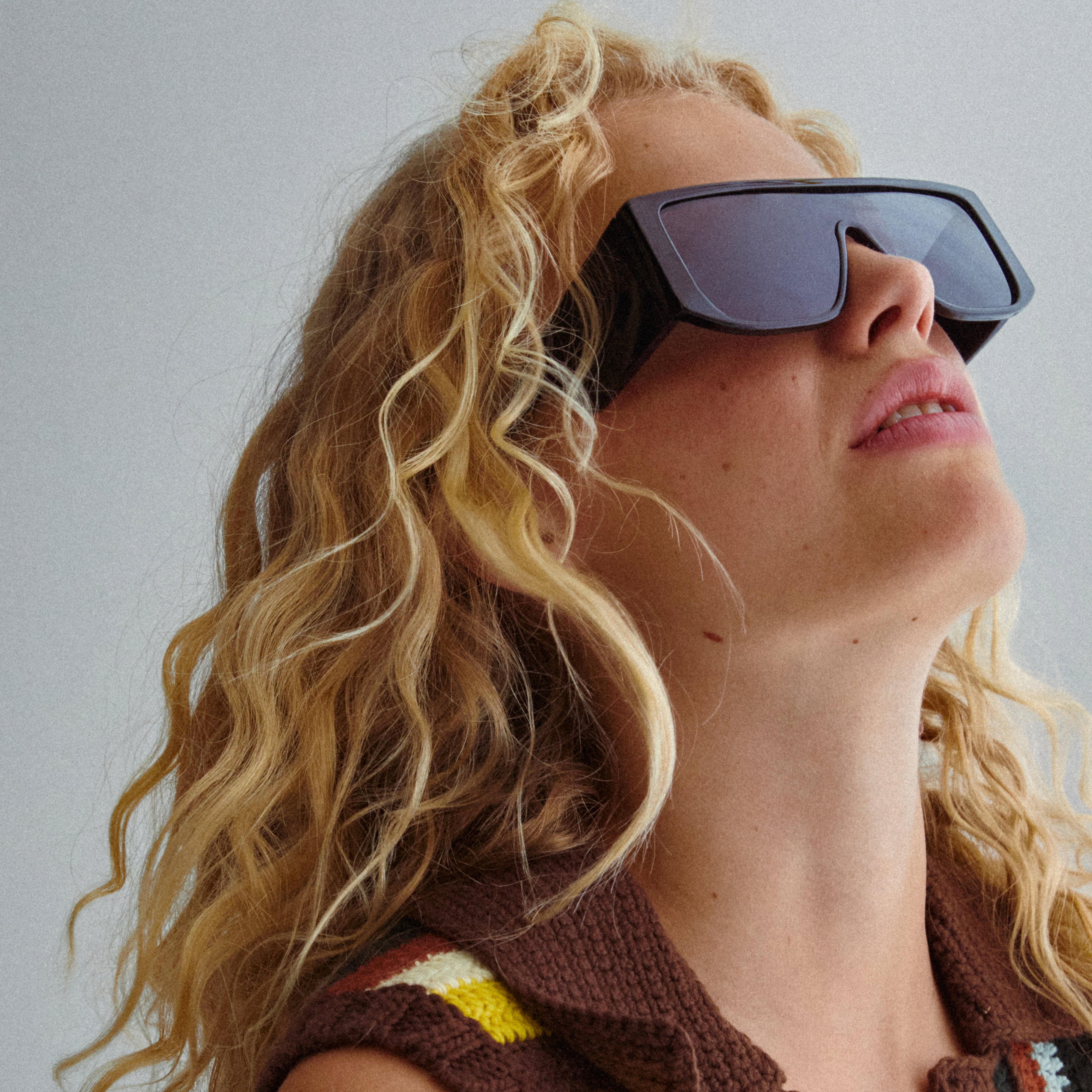 Johari sunglasses black on a woman, showcasing oversized frames and broad temples, embodying trendy L.A. style with sustainable design and UV protection.